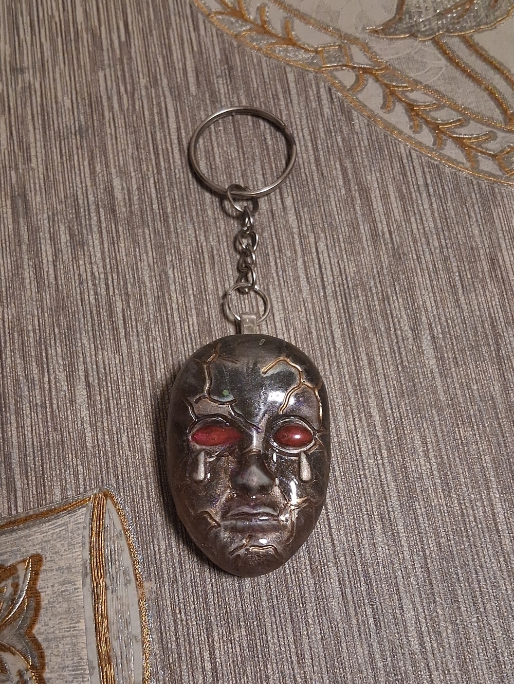 Silver-tone ,Goldtone Mask Keychain with Red Eye Accents